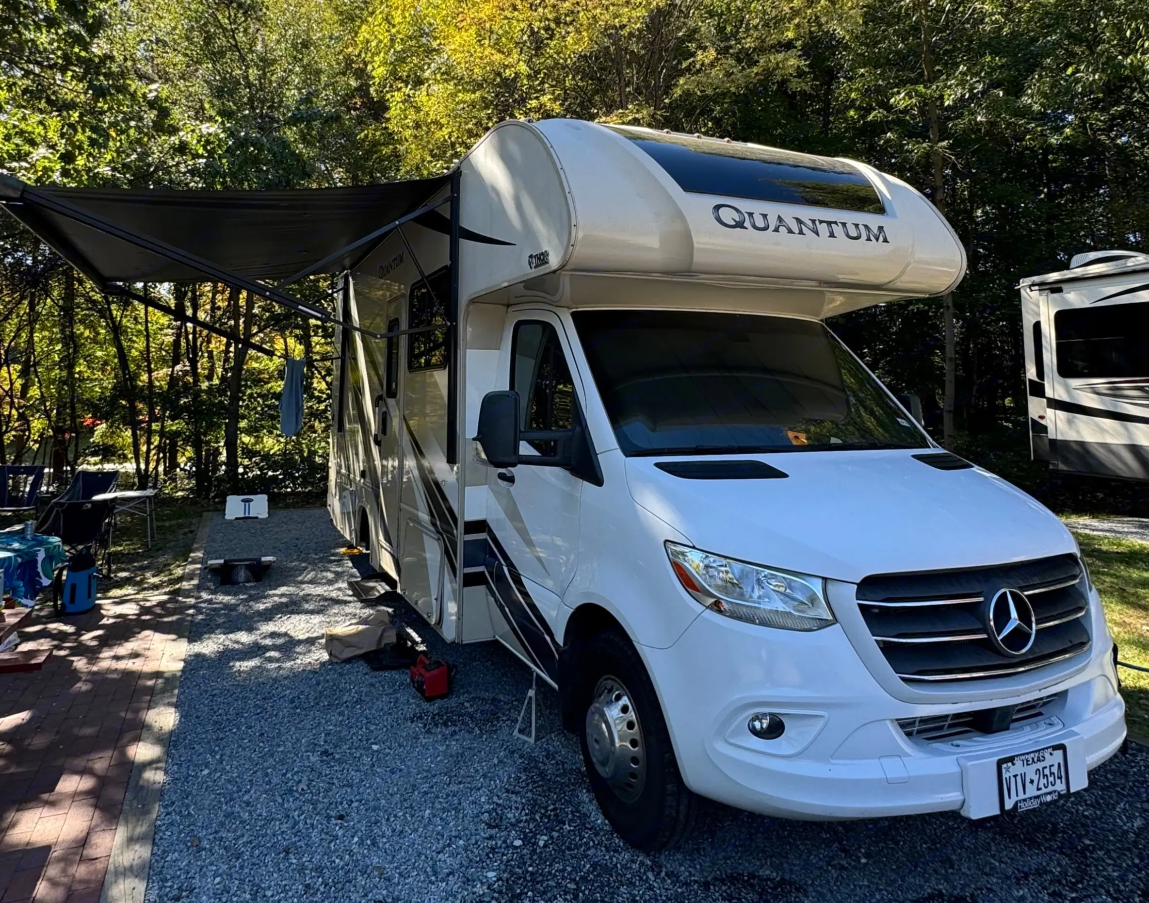 Exterior of the rig with awning fully extended, creating amble outdoor covered seating space, as well as protecting the entry area.
This is a beautiful park in Maryland!. Thor Quantum 2022