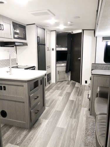 fully stocked rv with an outdoor kitchen
