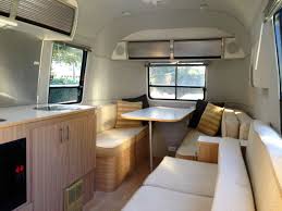 Spacious, modern Airstream travel trailer interior, ideal for your next RV rental adventure. Features a comfortable dinette and couch.. Airstream Safari 2008