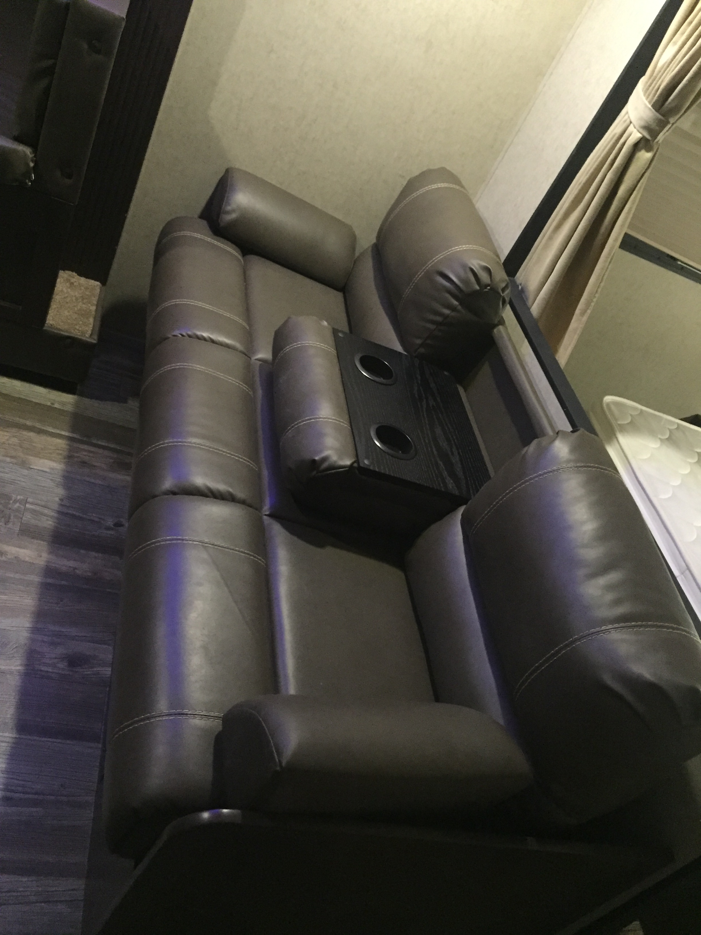 Plush grey recliners with integrated cup holders provide luxurious comfort in this RV rental. Perfect for relaxing after a day of travel.. Forest River Cherokee Grey Wolf 2016