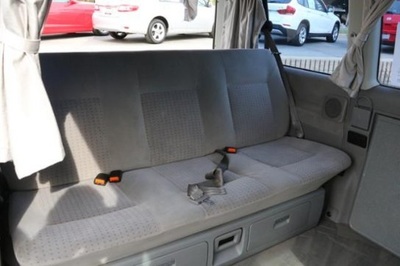 RV rental interior: comfy gray bench seat with under-seat storage, likely converts to a bed. Perfect for travel.. Volkswagen Eurovan MV 2002