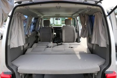 RV rental interior: rear seats fold flat, forming a spacious bed. Ideal camper van for road trips.. Volkswagen Eurovan MV 2002