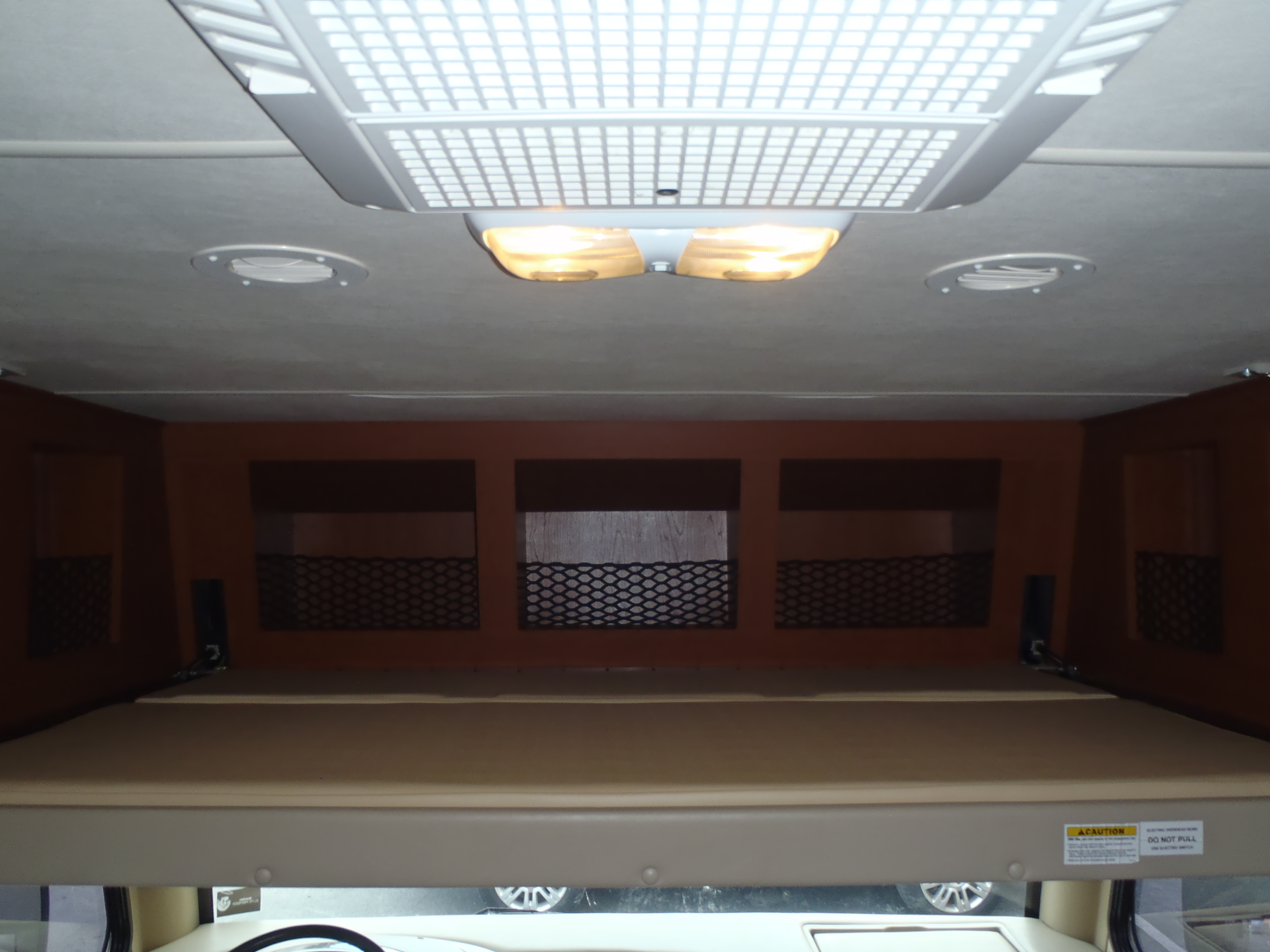 RV rental: Cozy cab-over bunk with mattress, convenient storage, and ceiling AC unit/lights.. Thor ACE 2012