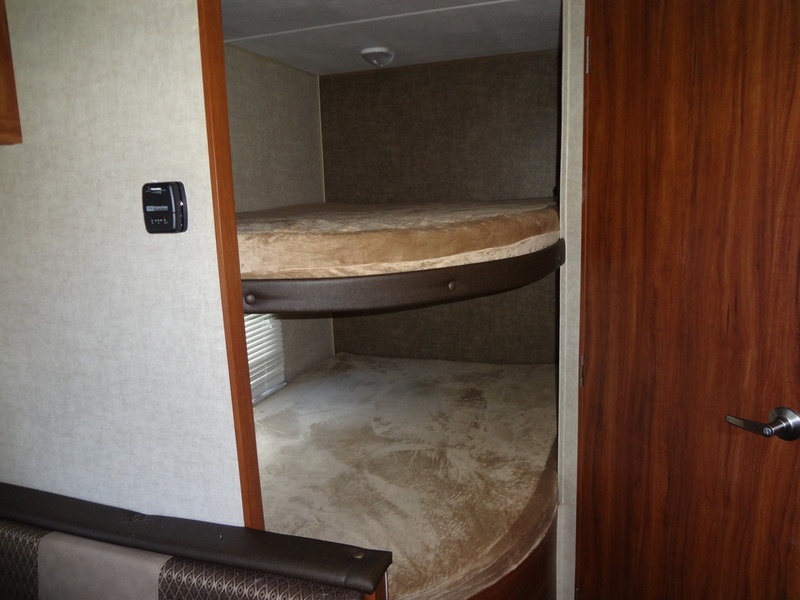 RV rental bunk beds within a travel trailer interior, offering cozy sleeping space for adventure-filled family trips.. Heartland Trail Runner 2017