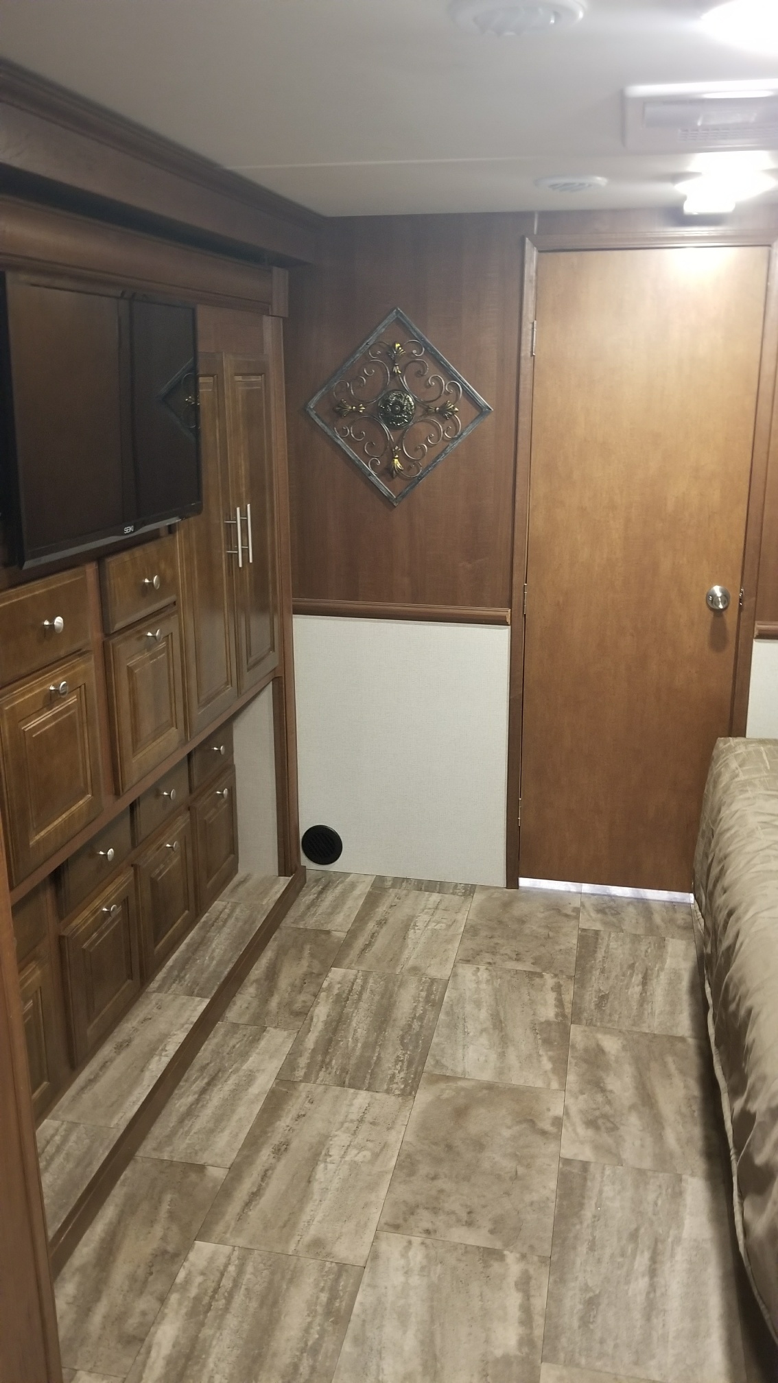 Cozy RV rental interior with wood cabinetry, tiled floors, and a glimpse of the bedroom, perfect for travel.. Forest River Georgetown 2017
