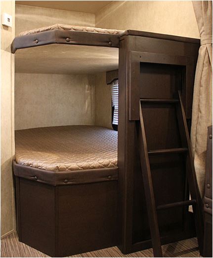 Inside an RV rental: a cozy bunk bed setup with ladder for compact sleeping arrangements.. Forest River Evo 2850 2019