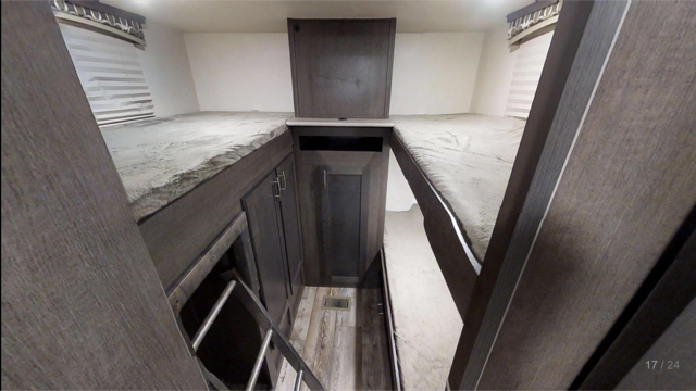 This RV rental showcases a cozy bunkhouse area with triple beds, including elevated and lower bunks, and built-in storage.. Forest River sonoma 2018