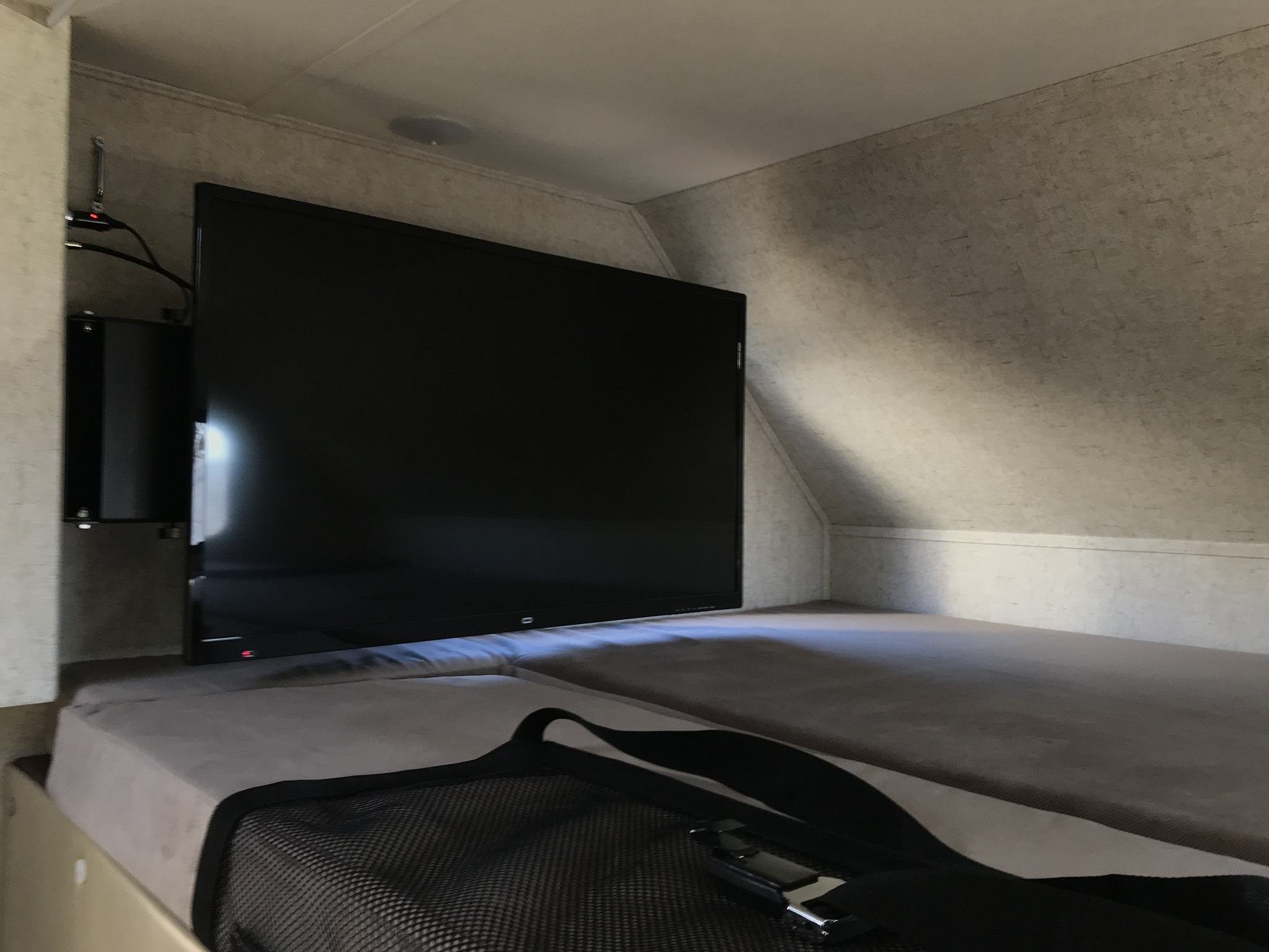 RV rental interior: A flat-screen TV is mounted beside a cozy bunk bed, providing entertainment in this compact setup.. Forester 3271 LE 2018
