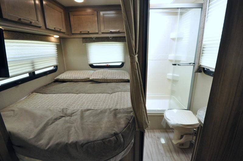Inside this RV rental, find a comfortable bed with storage and a convenient bathroom featuring a shower and toilet. Travel in comfort!. Other Other 2019