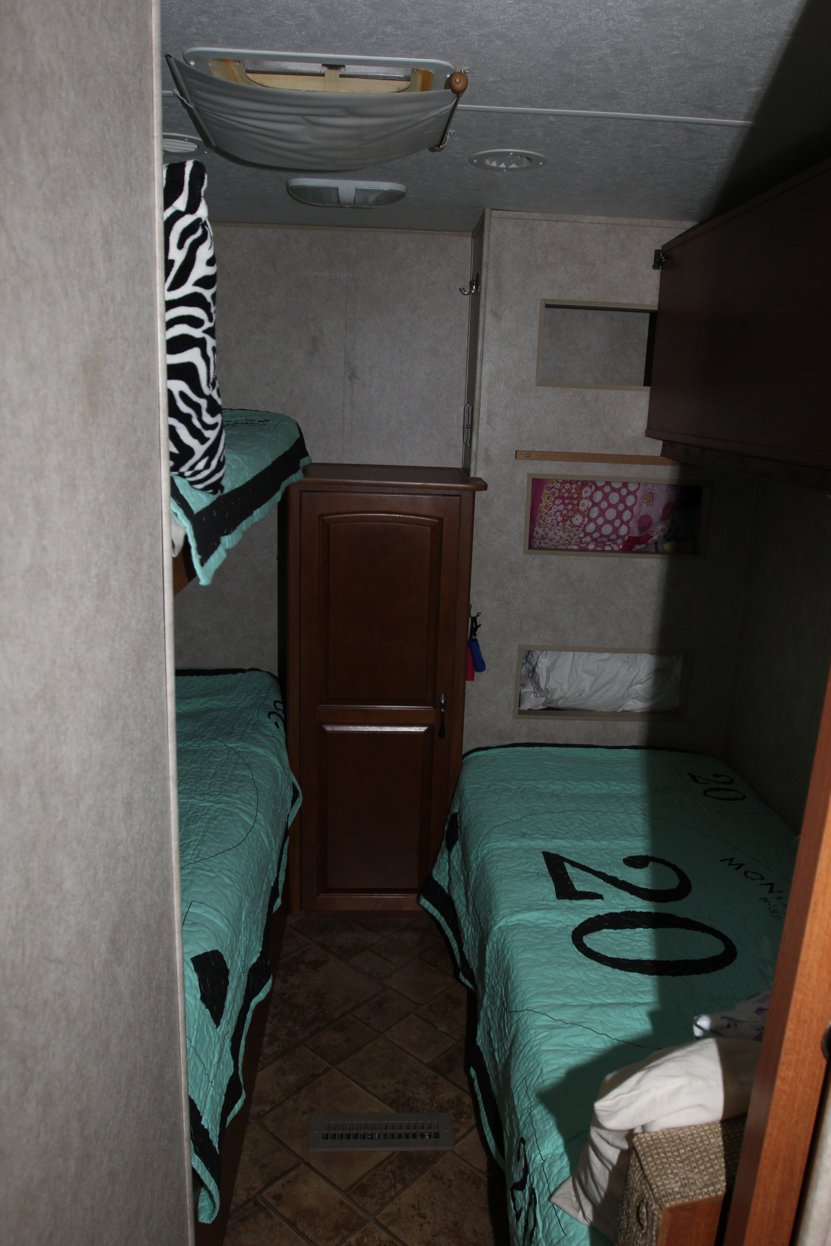 RV rental interior: features bunk beds (zebra blanket) & twin beds (teal quilts). A comfortable sleeping area for your trip.. Forest River Surveyor 2010
