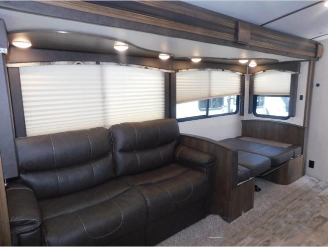 RV rental living space: comfy sofa, convertible dinette, bright windows.. Keystone Cougar Half-Ton 2019