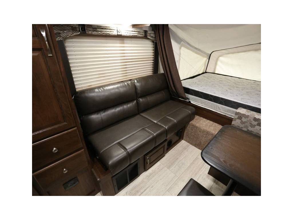 RV rental living space: comfy sofa, pop-out bed, and storage. Perfect for camping & road trips.. Palomino 2018 Solaire 18 foot Hybrid travel trailer sleeps 8 2018