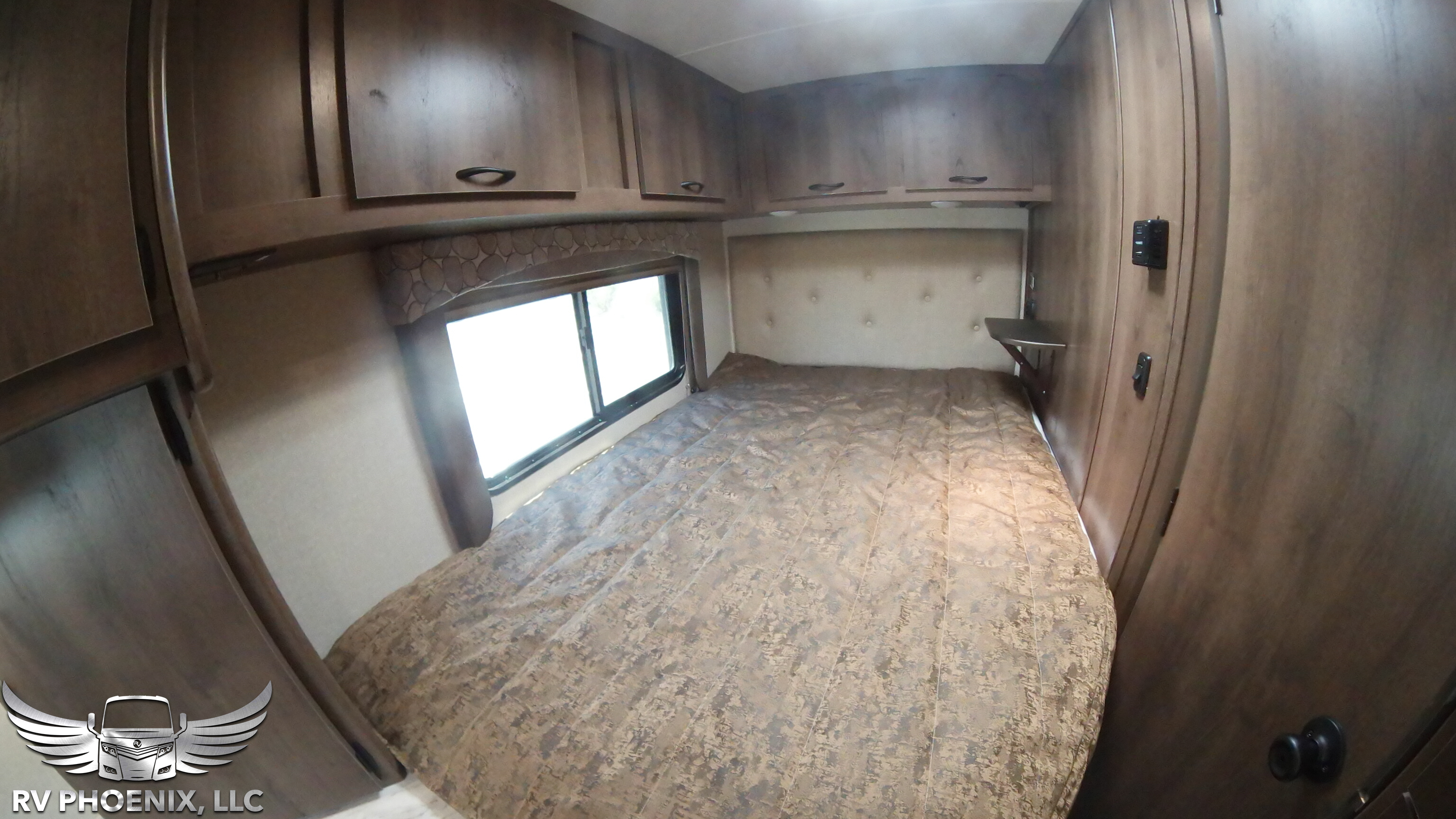 RV rental bedroom: Features a comfortable bed, overhead cabinets, and a window for natural light.. Coachmen Freelander 2019
