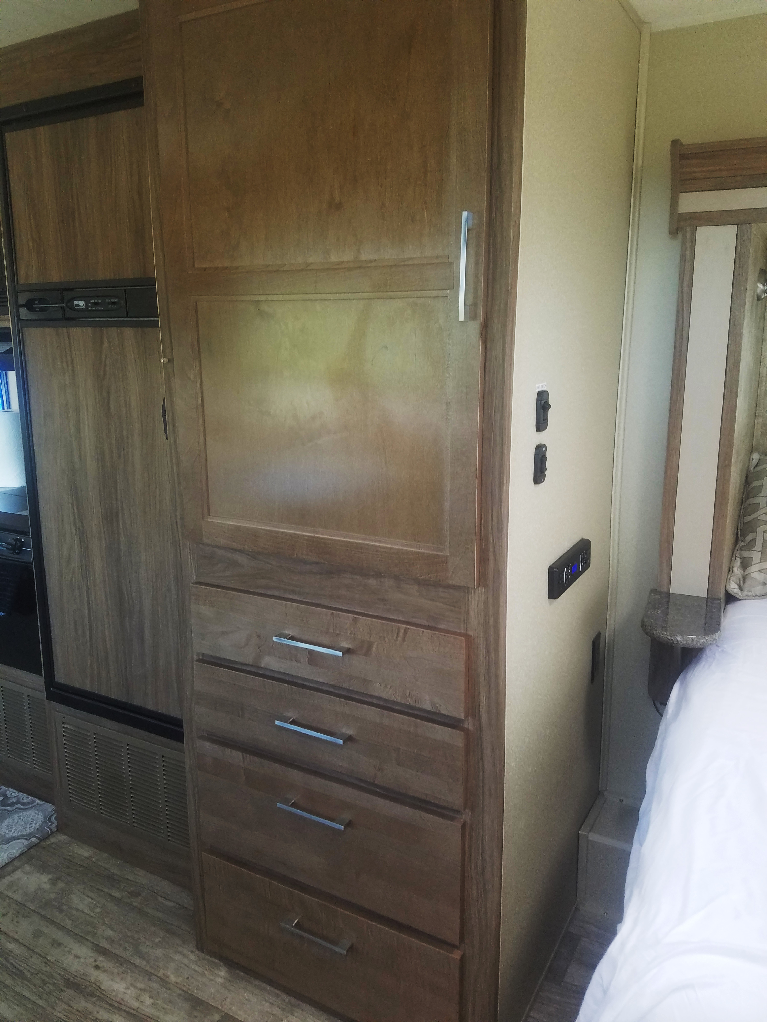 RV rental: Interior view with built-in wood cabinets, drawers, a refrigerator, and part of the bedroom area.. Jayco Envoy 2018