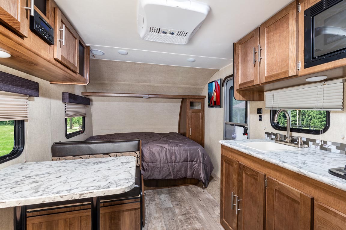 Spacious RV rental interior with kitchen, dinette, and comfortable sleeping area. Perfect for your next adventure!. Gulf Stream 199DD 2019