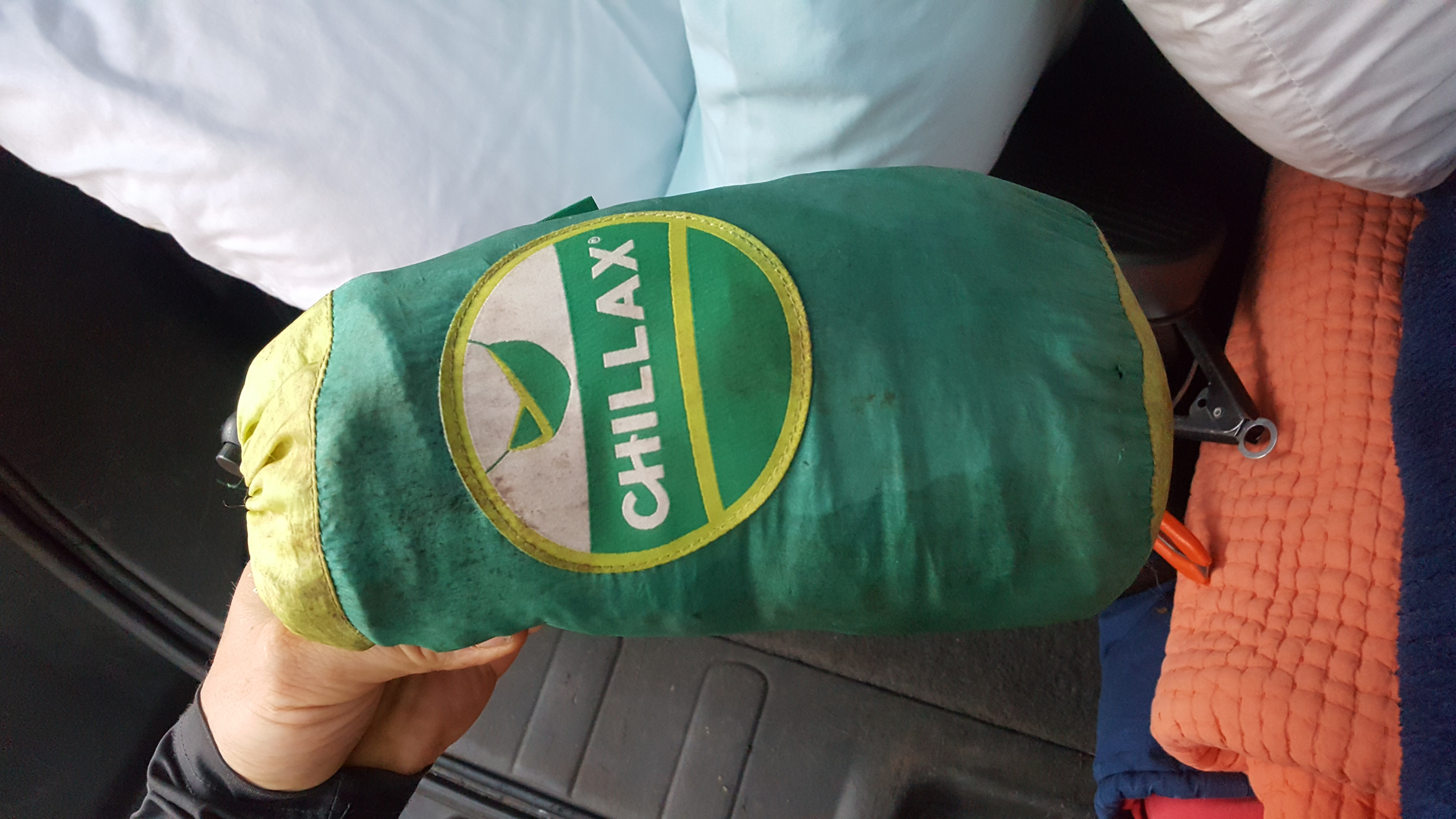 Packing a green Chillax gear bag for our RV rental adventure, shown inside the vehicle.. Nissan XTERRA 2014