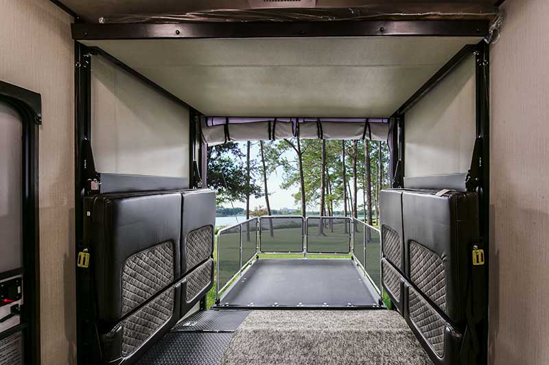 RV rental's versatile toy hauler with fold-down seating and a scenic lakeside patio deck for outdoor enjoyment.. Heartland Torque t322 2019