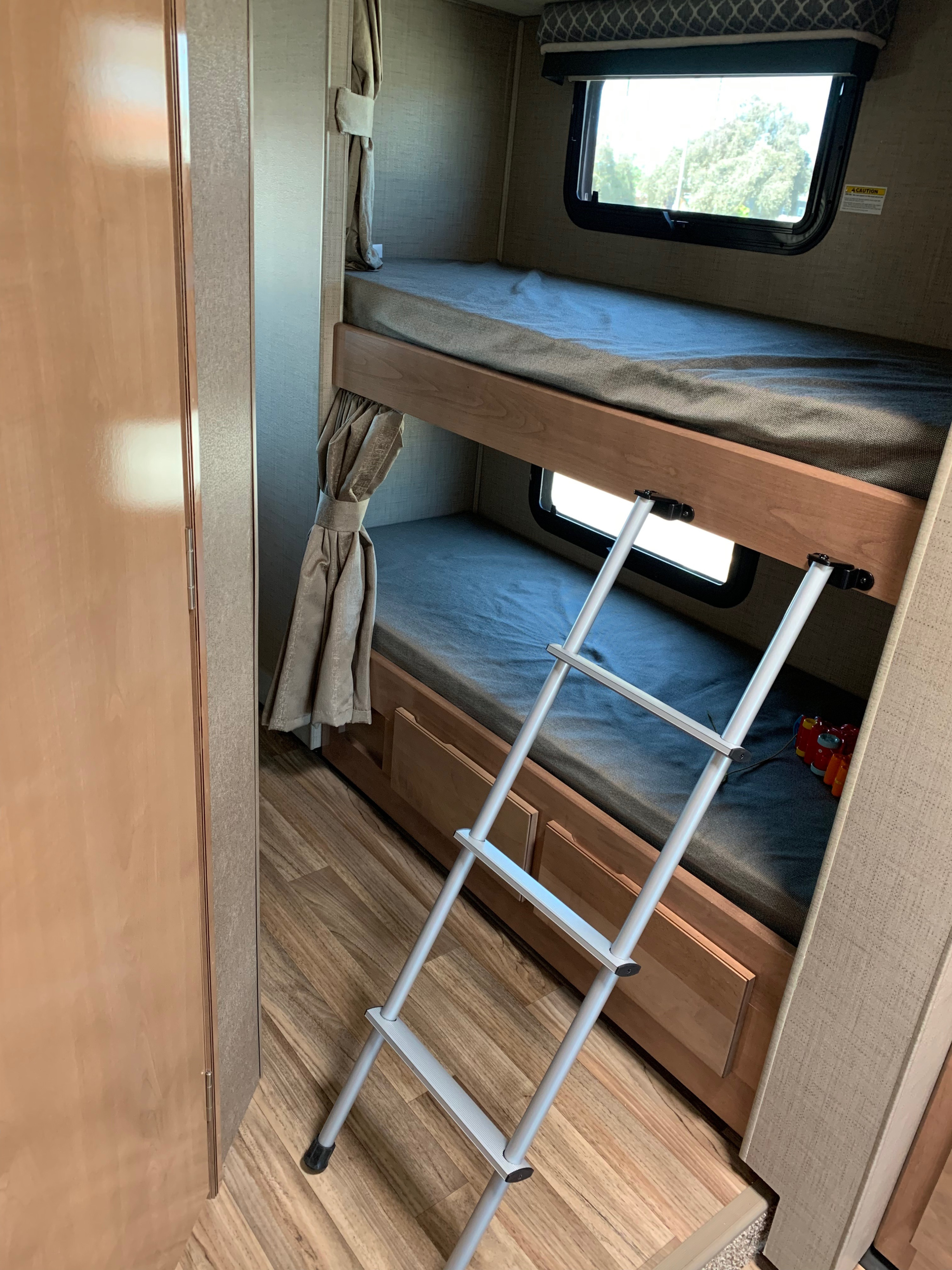 Inside an RV rental: comfortable bunk beds with a ladder for easy access. Great for kids on family trips.. Thor Quantum 2019