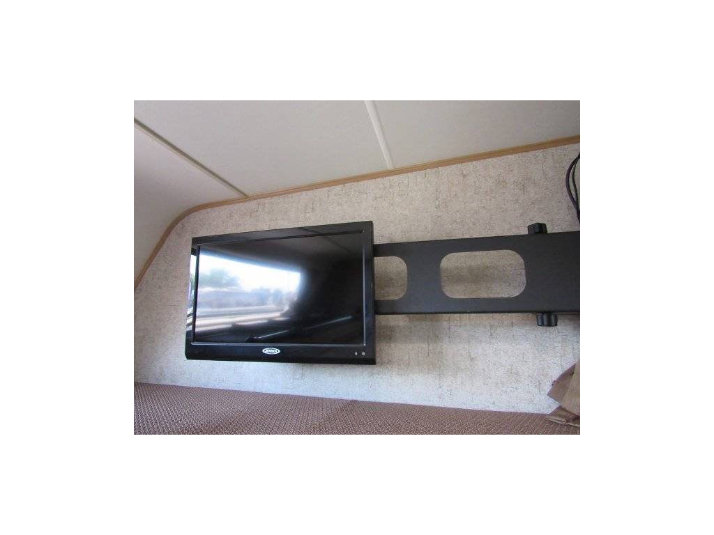RV rental interior featuring a flat-screen TV mounted on a wall bracket. Perfect for entertainment on your trip.. Forest River Coachmen Leprechaun 2017
