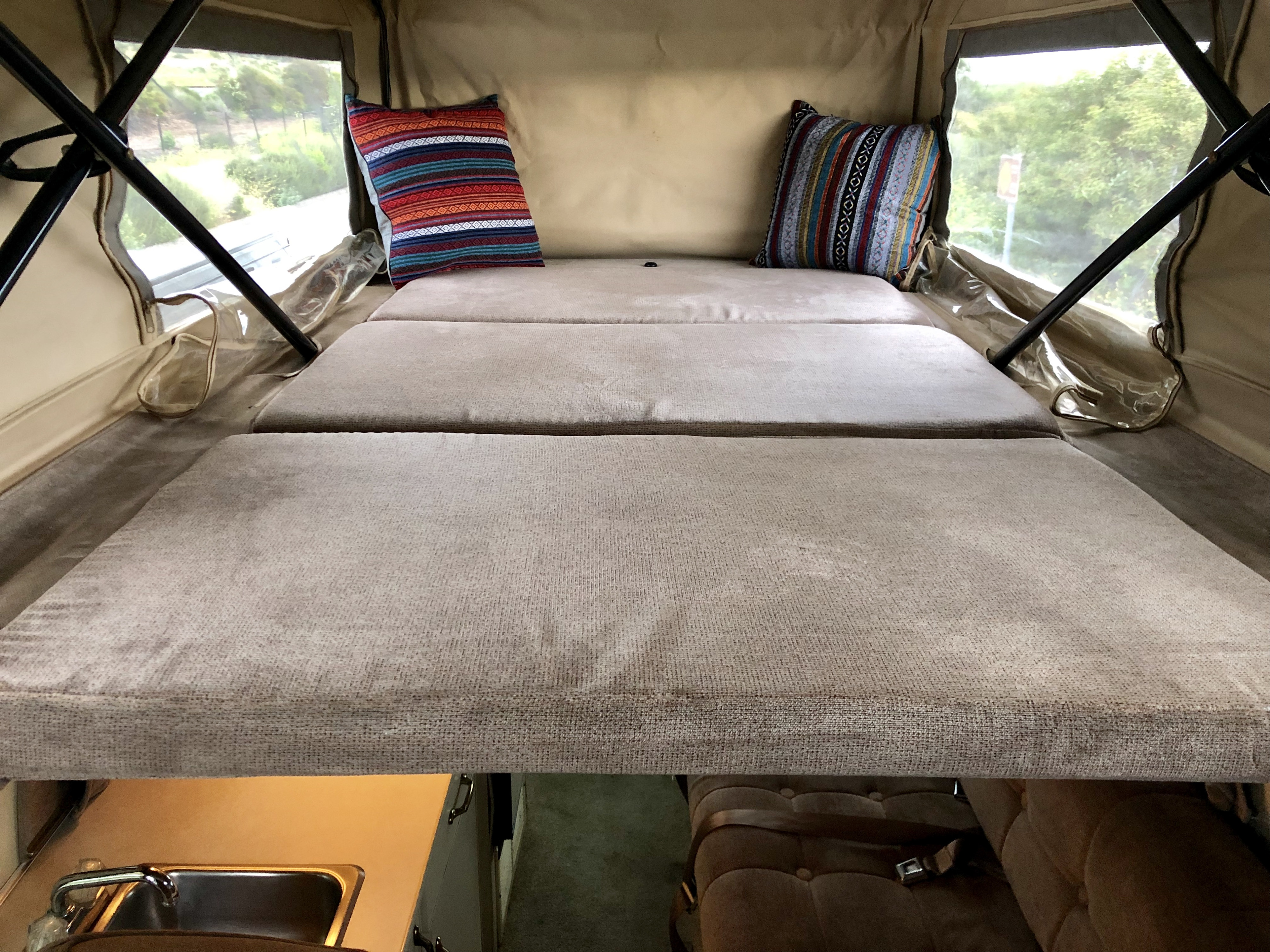 A full-size bed in the pop top.. Ford Econolline 250s 1998