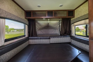 Inside this hybrid RV rental: Cozy dinette converts to a bed, large windows offer scenic outdoor views. Ideal for your next road trip.. Jayco Jay Feather Ultra Lite 2017