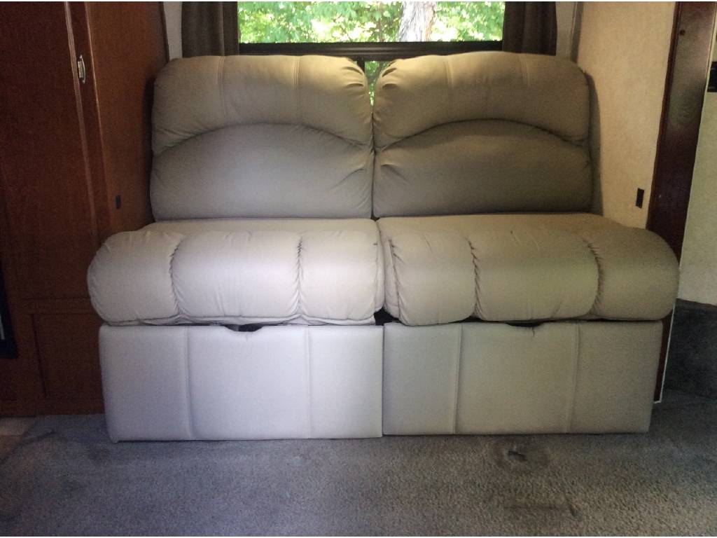 RV rental: Light-toned convertible RV sofa/bed. Plush seating and sleeping area in a modern RV interior.. Phoenix USA Cruiser 2552 2011