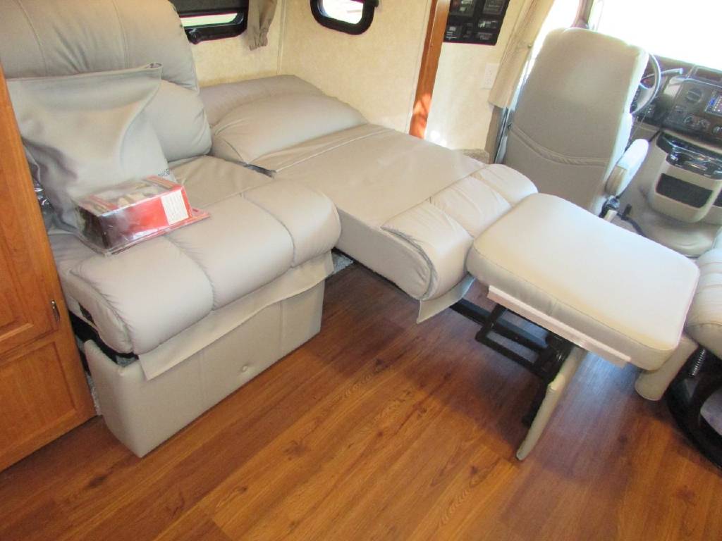 Comfortable RV rental interior with versatile seating that converts to a bed and includes an ottoman.. Phoenix USA Cruiser 2552 2011