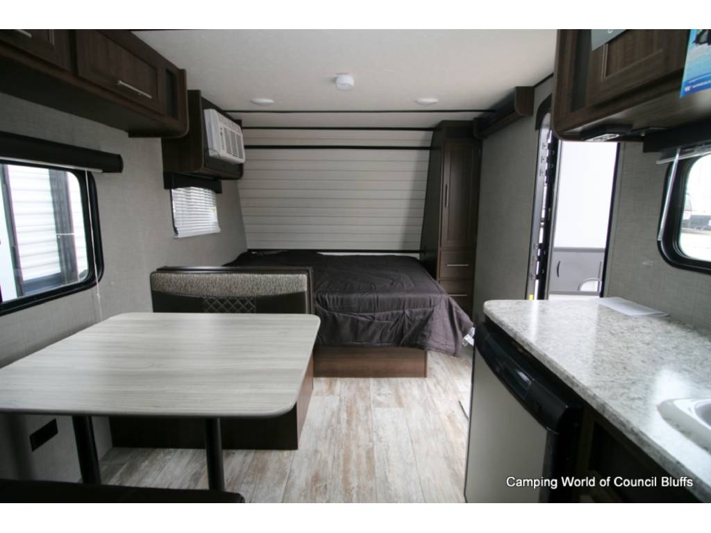 This RV rental features a bed, dining area, & kitchen counter with sink & appliances. A practical camper interior.. Crossroads Zinger 2020