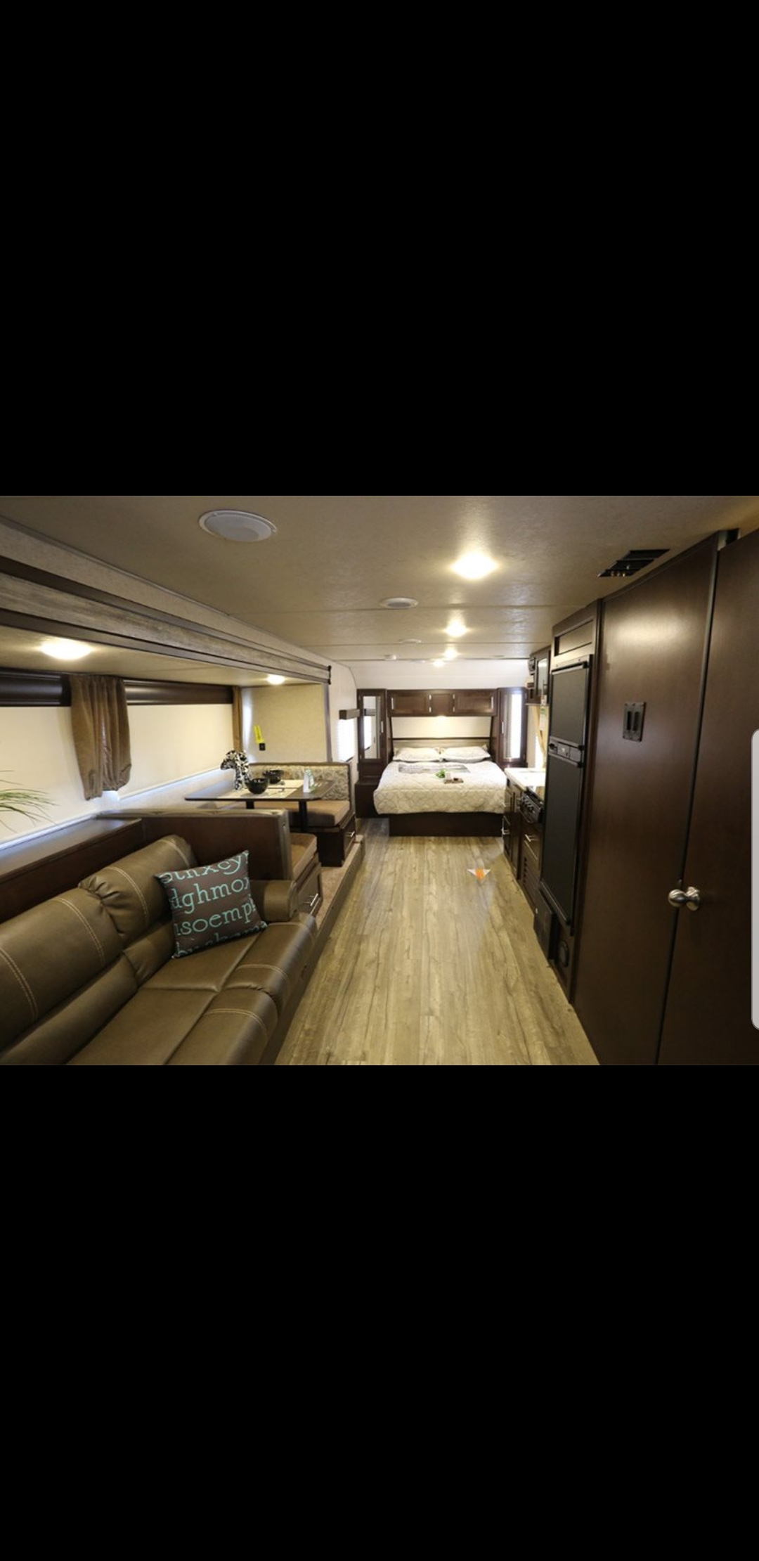 RV rental: Spacious interior with a brown sofa, dinette, full kitchen, and bedroom with a queen bed. Light wood flooring.. Forest River Cherokee Patriot limited edition 2017
