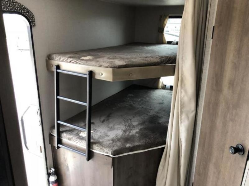Inside an RV rental, two bunk beds with a ladder, window, and privacy curtain. Perfect for family camping trips.. K-Z Manufacturing Other 2019