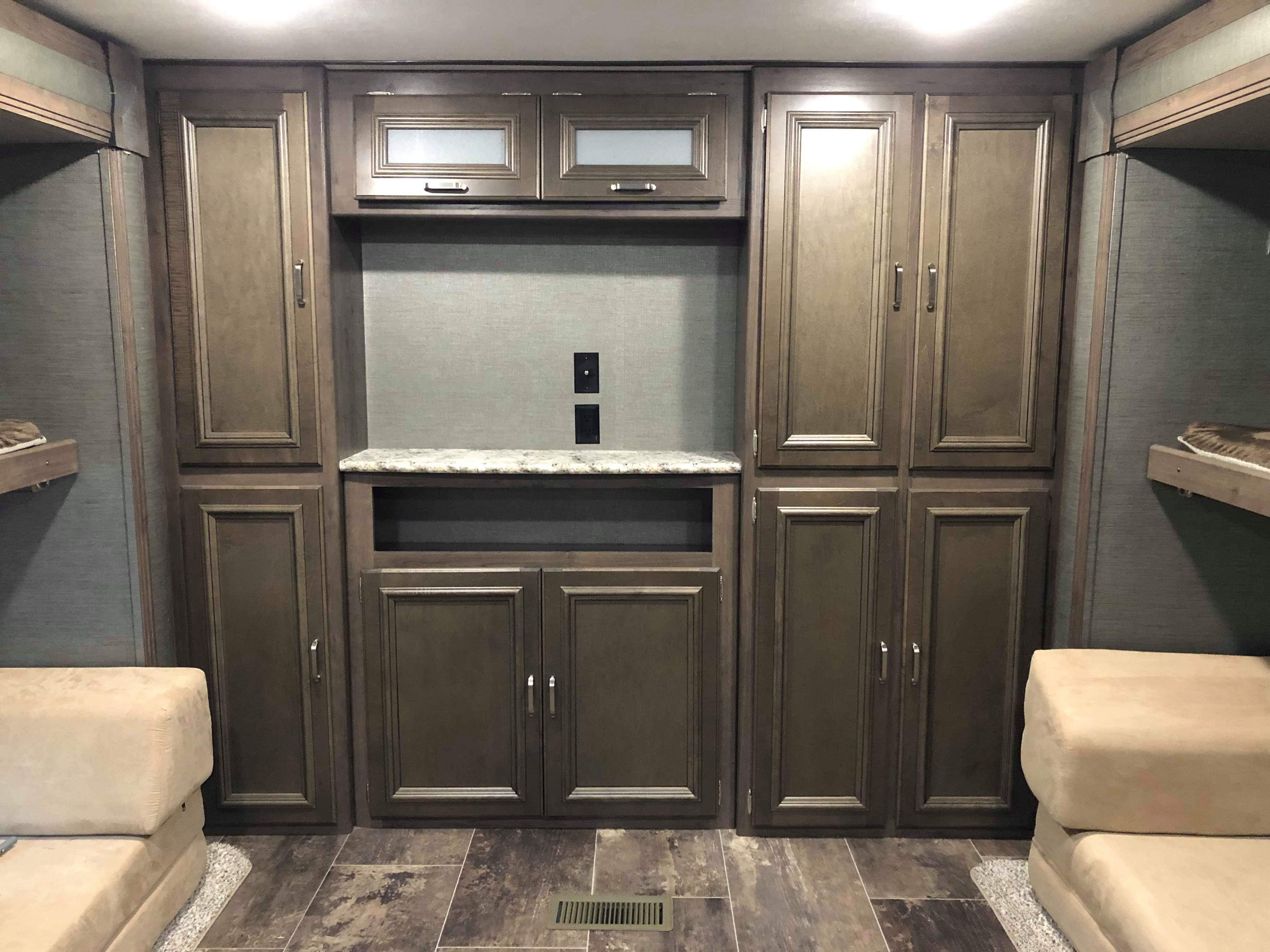 RV rental interior with ample storage, counter, bunk beds, and modern finishes. Ideal for travel comfort.. Keystone Passport 2019