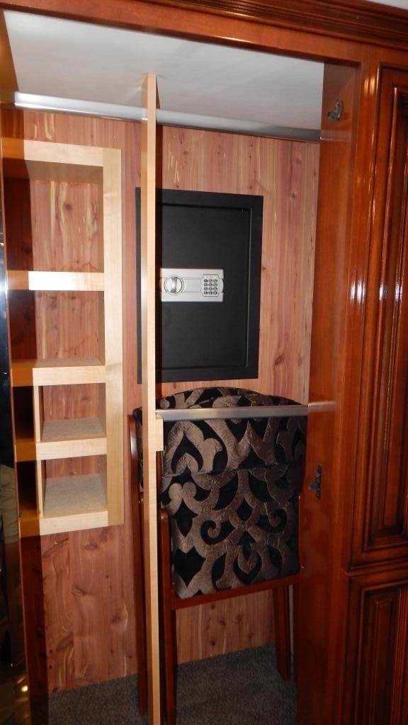 This RV rental's cedar-lined closet offers smart storage with shelving, a digital safe, and a tucked-away seat.. Newmar Essex 2018