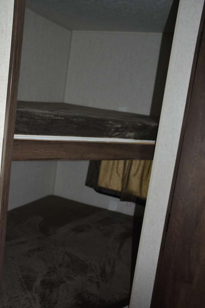 RV rental interior: two stacked dark bunk beds, efficiently designed for extra sleeping space.. Starcraft Autumn Ridge 2019