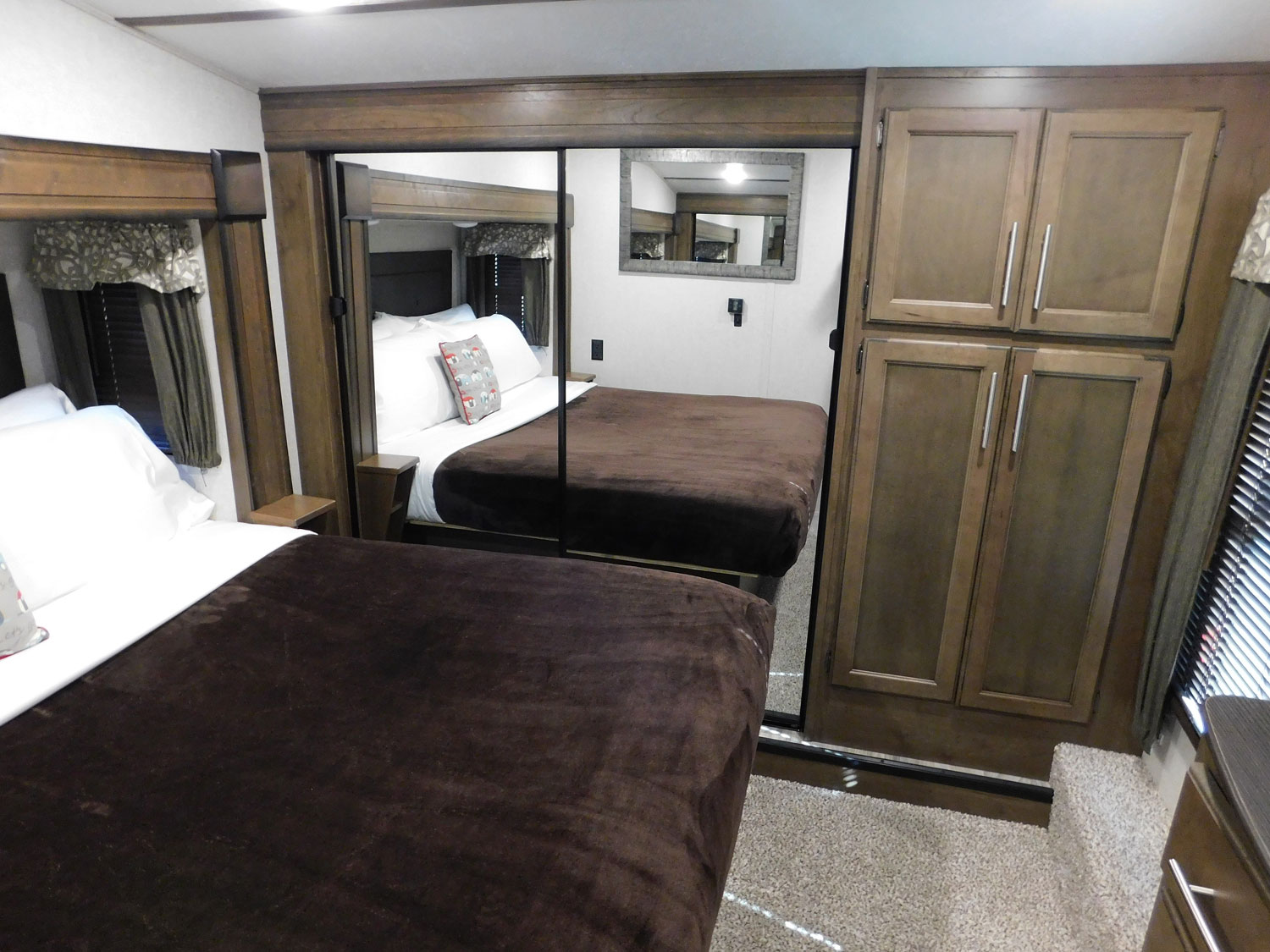Spacious RV rental bedroom with two comfortable beds, mirrored closet, and ample storage. Perfect for family trips.. KEYSTONE 369BHS 2019