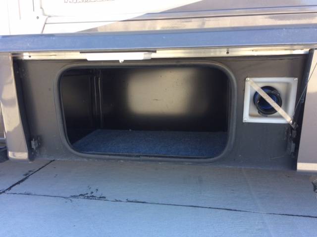 RV rental: Open exterior storage bay with blue carpet and utility access. Ample space for gear.. Winnebago View 2015