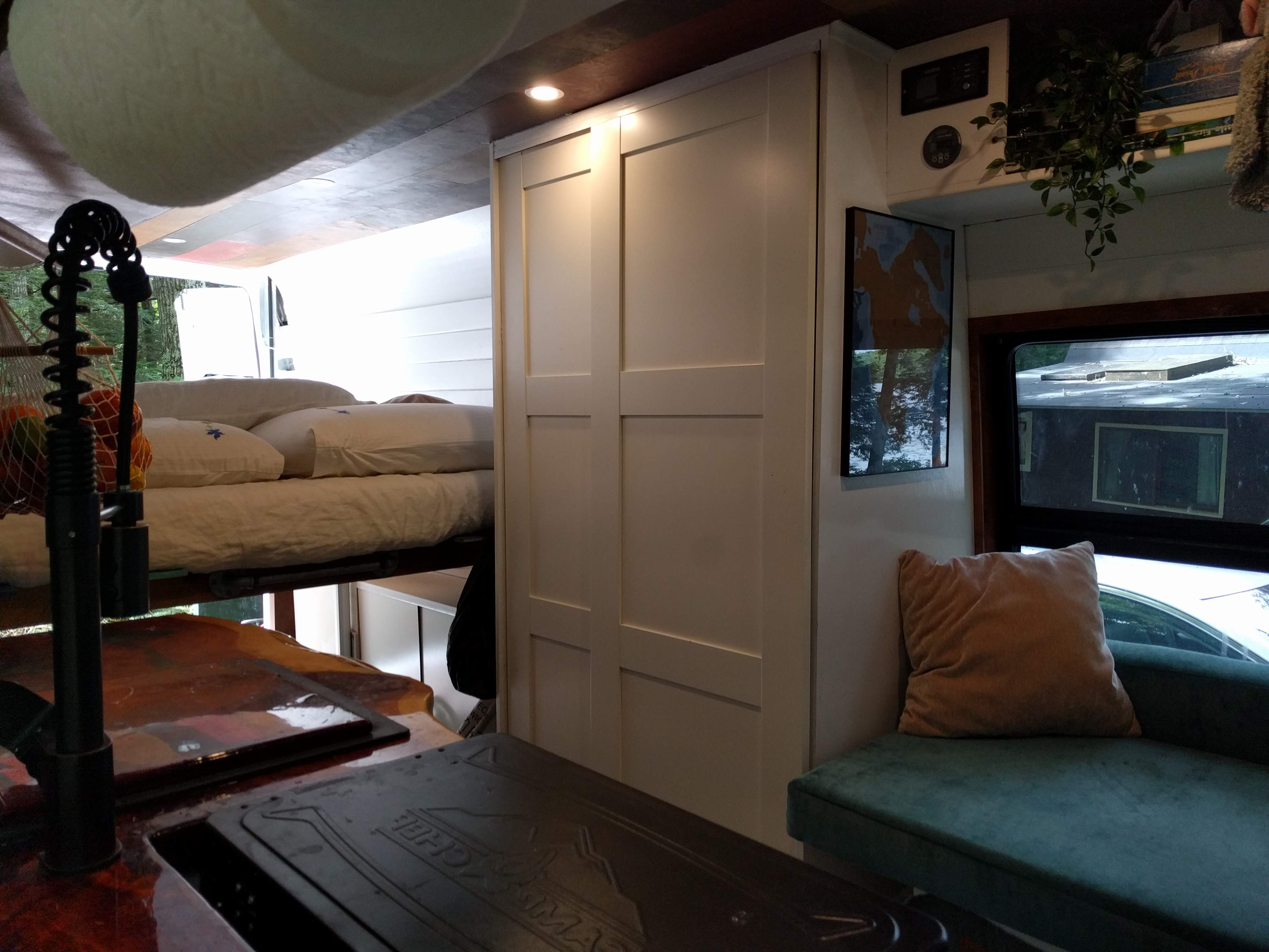 Step into this cozy rv rental, showcasing a built-in kitchen, elevated bed, and lounge area. White cabinets offer smart storage.. Mercedes-Benz Sprinter 2005