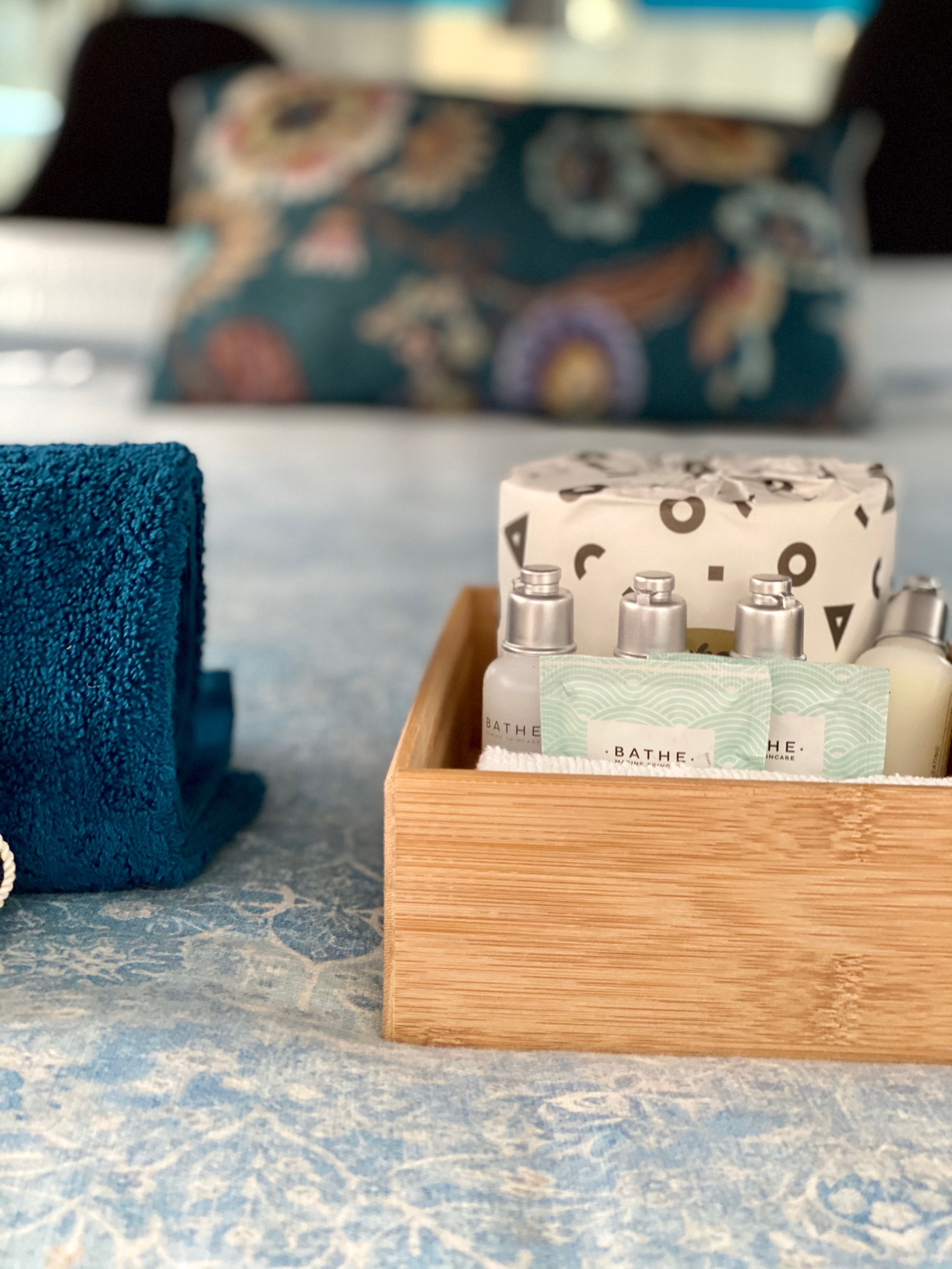 RV rental comfort: Teal towel & a wooden box of 'Bathe' toiletries and essentials, ready for your journey.. Mitsubishi Express 2003