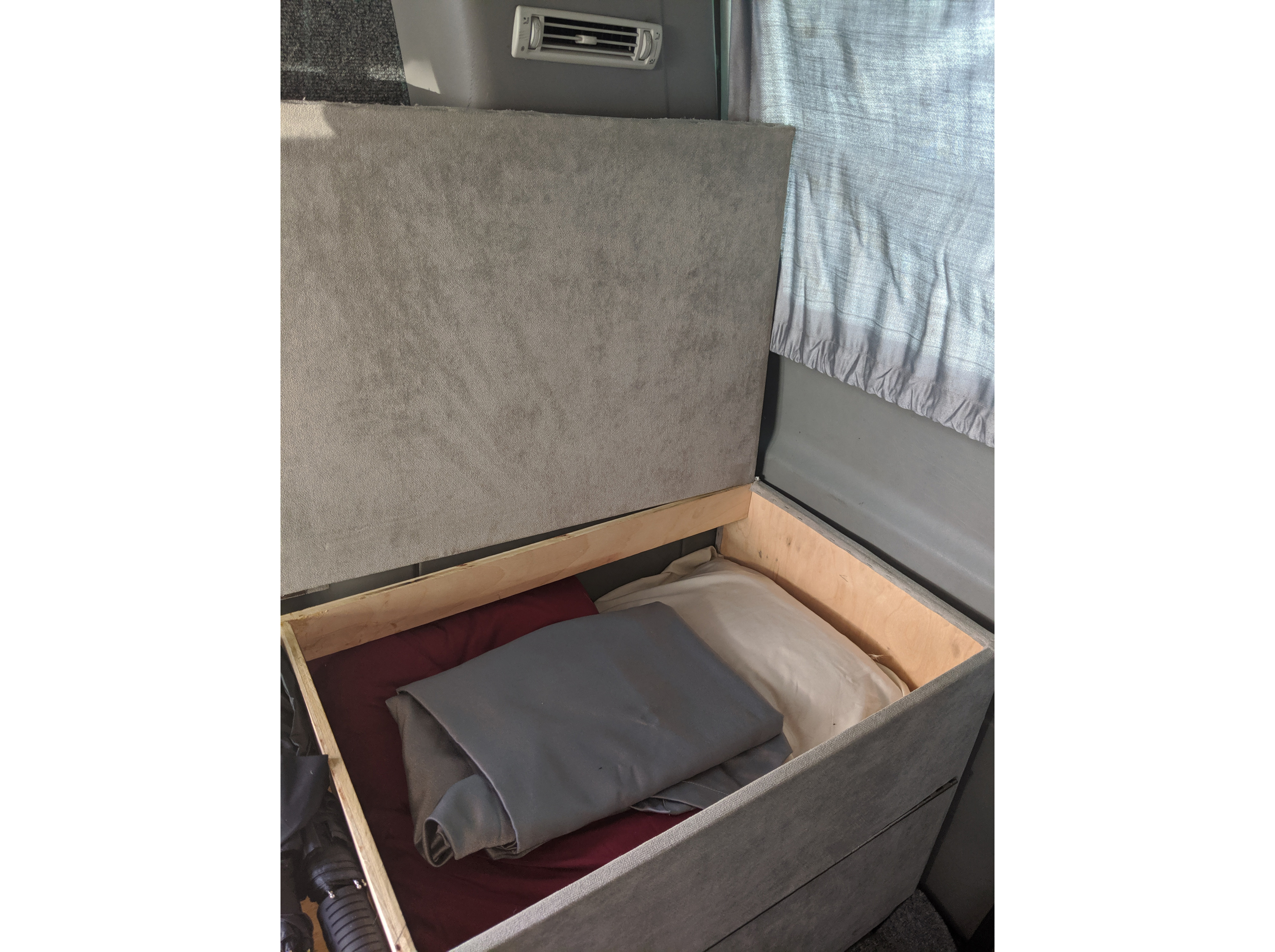RV rental: Lifted bed in van interior shows built-in storage. Holds pillows, blankets, and travel gear.. Volkswagen T4 Westfalia 2002