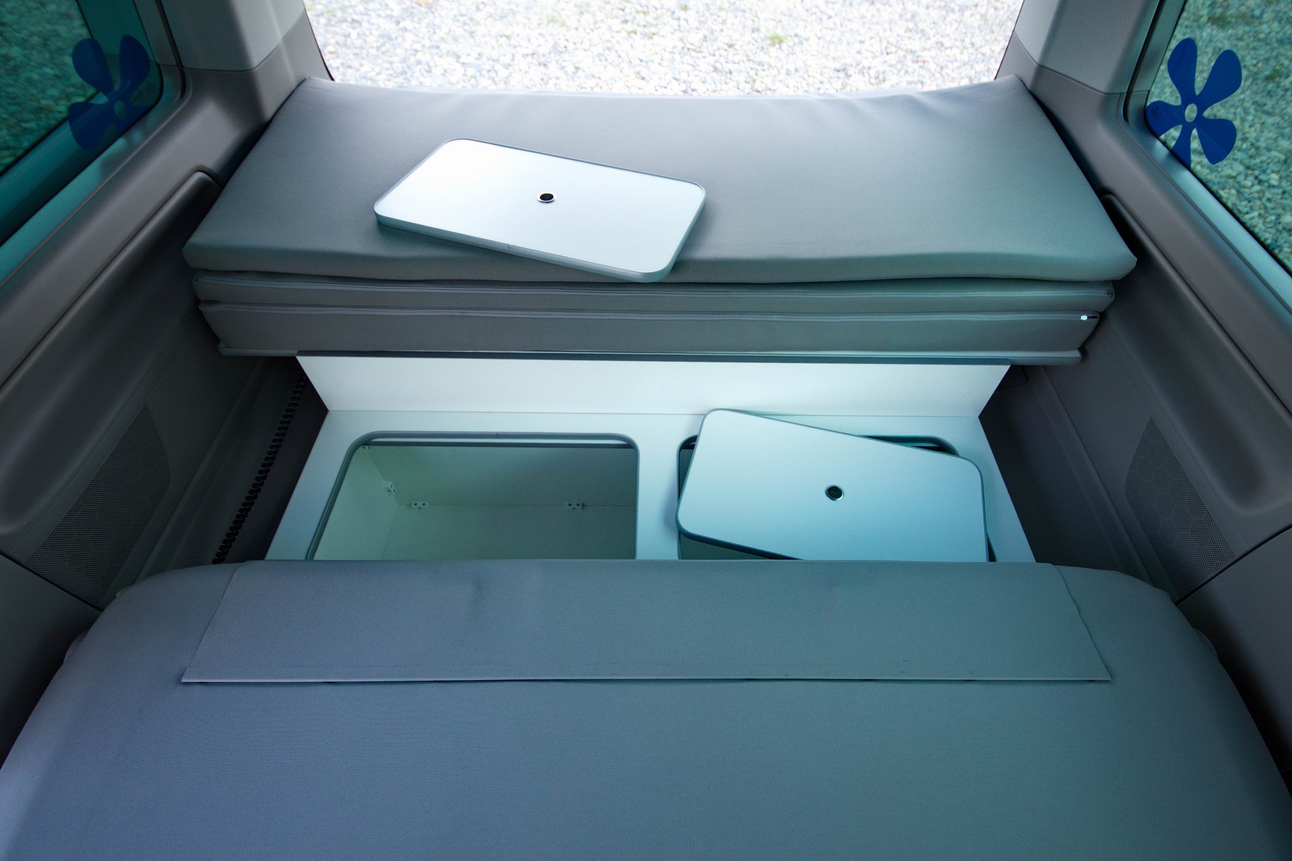 RV rental: Clever camper storage shows neatly stowed bed cushions & modular tables.. Volkswagen California Beach T6 2021