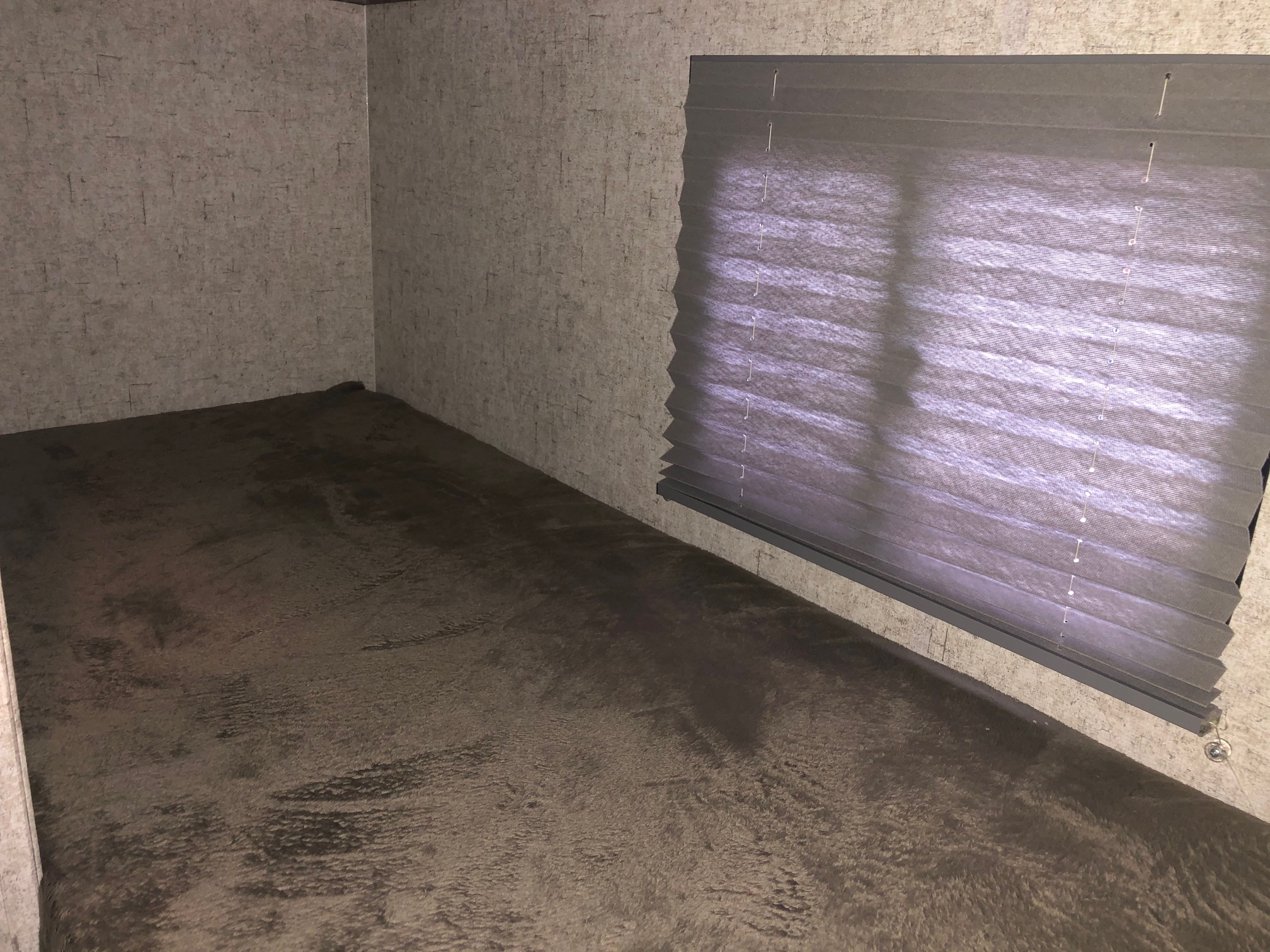 Interior view of an RV rental bunk bed. Features soft dark bedding, textured walls, and pleated window blinds.. Coachmen Apex Nano 2019