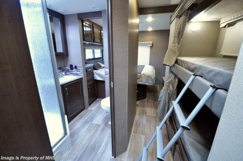 Inside an RV rental: Compact living space featuring a full bathroom, bunk beds, and a cozy main bedroom.. Thor Motor Coach Four Winds 2017