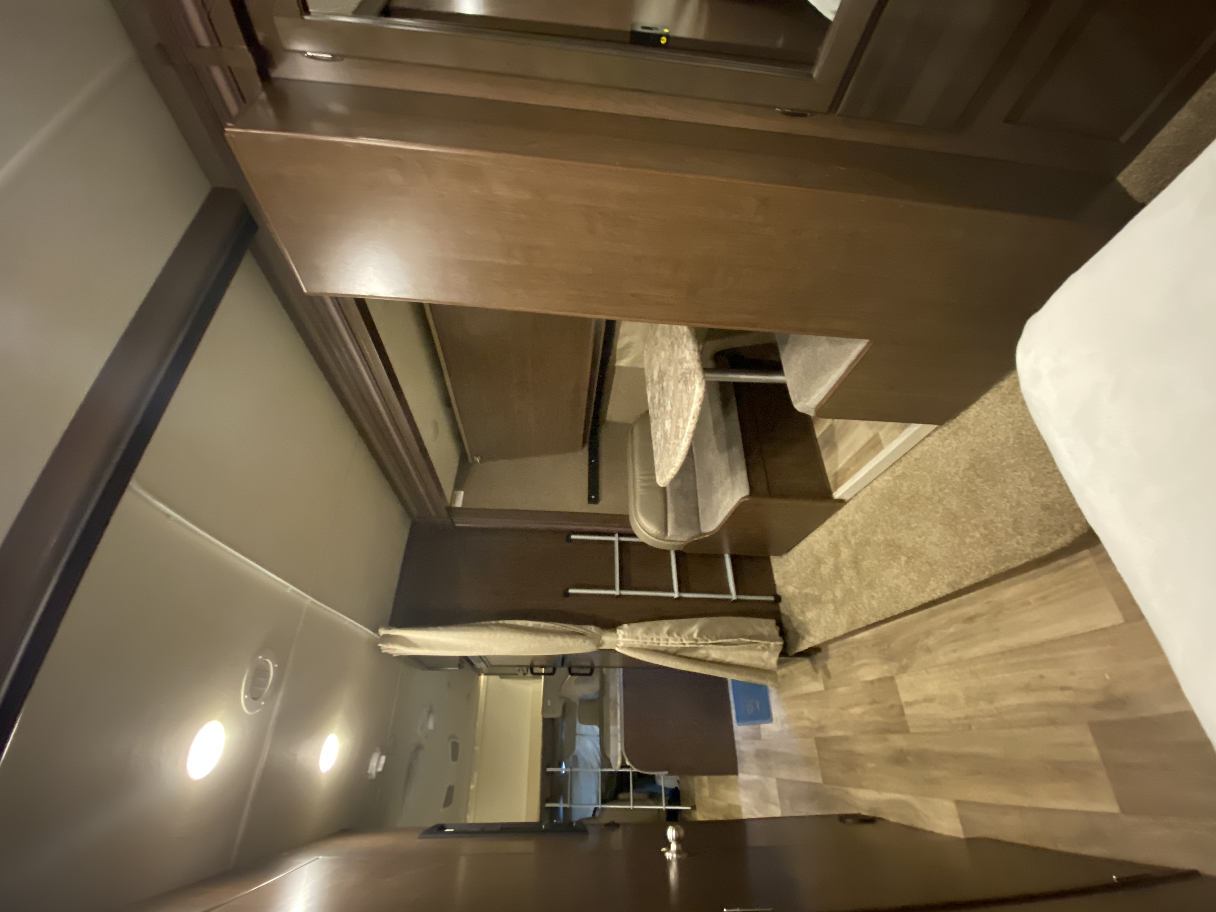 An RV rental interior featuring wooden bunk beds with a ladder, a dinette, and a comfy sleeping area.. Thor Motor Coach Freedom Elite 2019