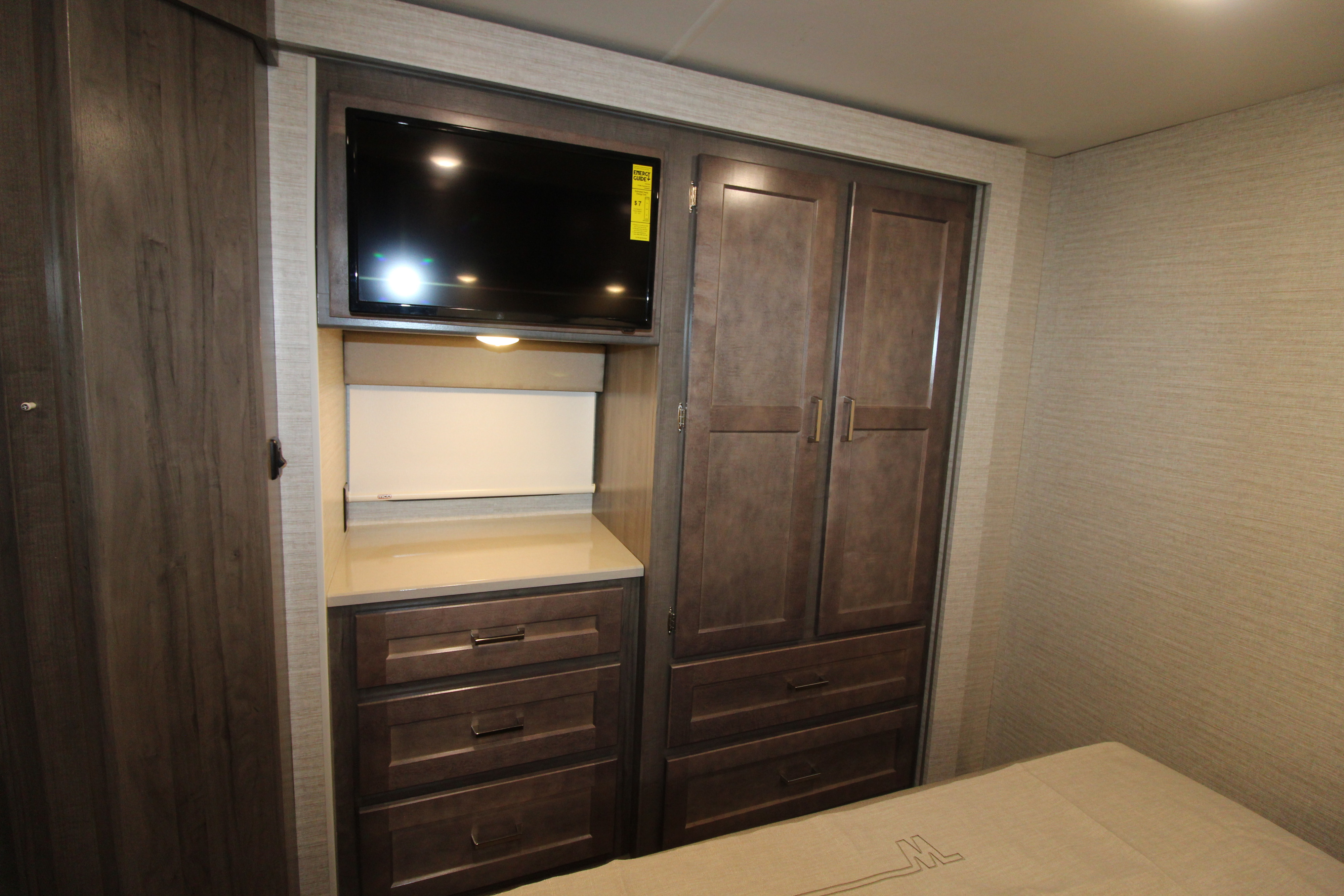 Spacious RV rental bedroom with TV, ample storage cabinets and drawers, perfect for your next adventure.. Winnebago Minnie Winnie 2020