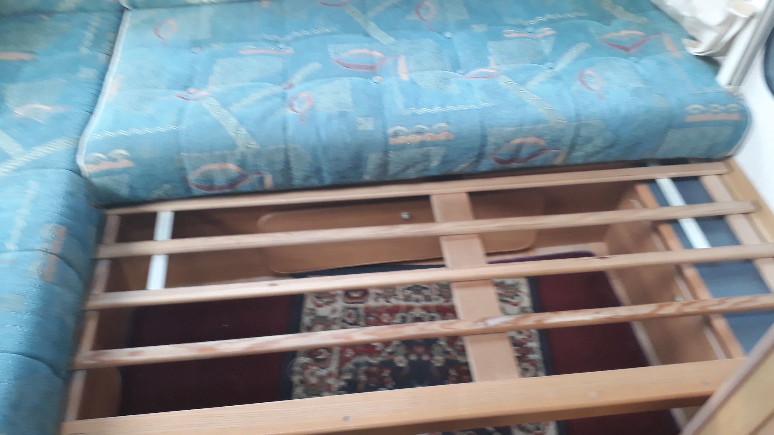 RV rental: Blue patterned cushions rest on a wooden slatted bed base, revealing under-bed storage.. Fiat Ducato Swift Suntor 2000