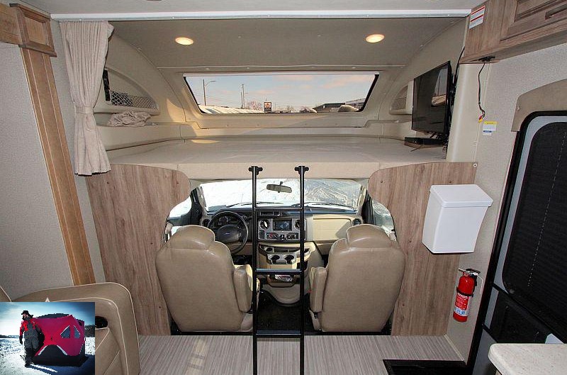 Experience an RV rental's front: a large cab-over bunk, access ladder, and cockpit area from the living space.. Jayco Greyhawk Prestige 2019