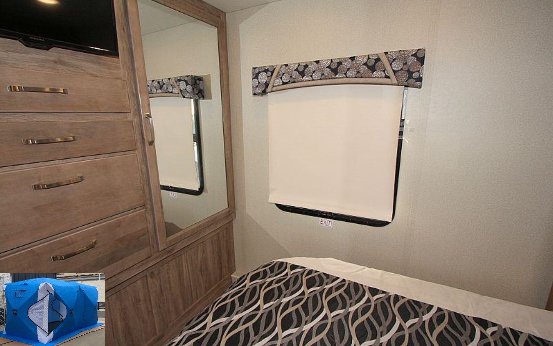 RV rental interior: bedroom view with dresser, mirror, bed, and window with 'EXIT' sign. Compact and functional.. Jayco Greyhawk Prestige 2019