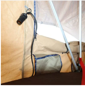 RV rental comfort: Interior view of a camper showing a hanging light, built-in storage, and sleeping space for easy camping.. Smittybilt Overlander XL RTT