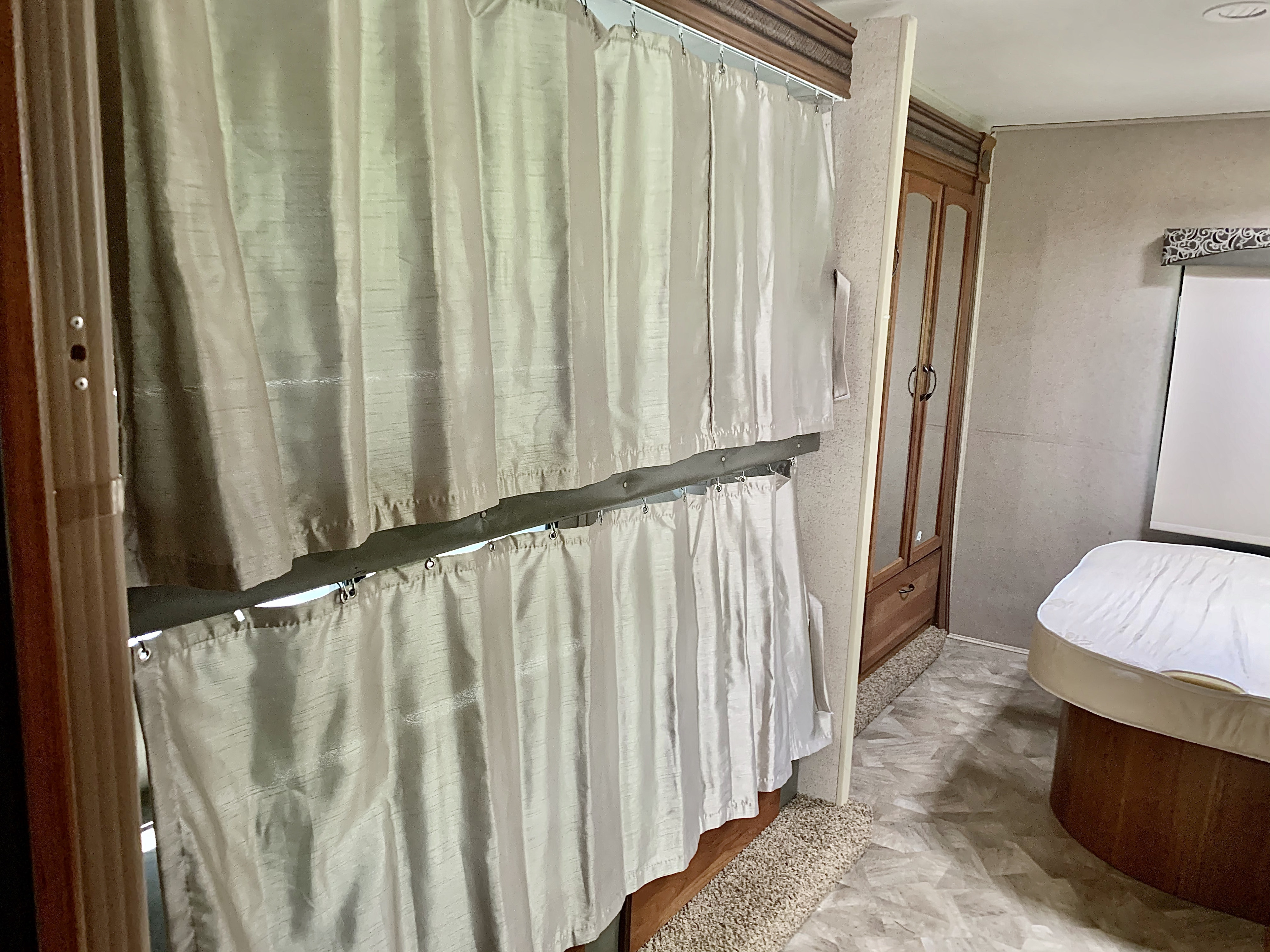 RV rental: Bunk beds with light privacy curtains, wood cabinet, and a rounded sleeping area inside.. Jayco Redhawk 2016