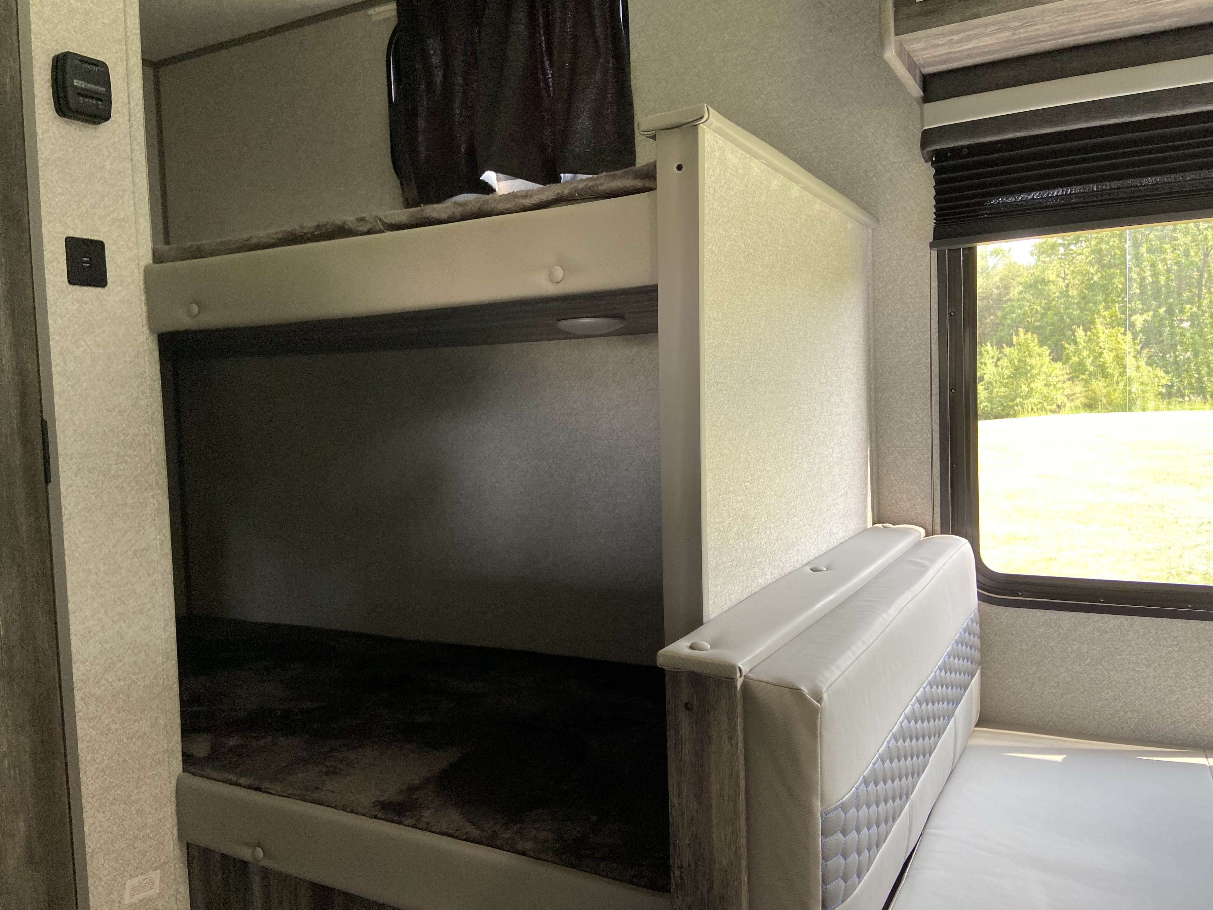 RV rental: Bunk beds, a dinette, and bright window inside. Features thermostat and USB for comfort.. Forest River 2020 Wildwood 2020