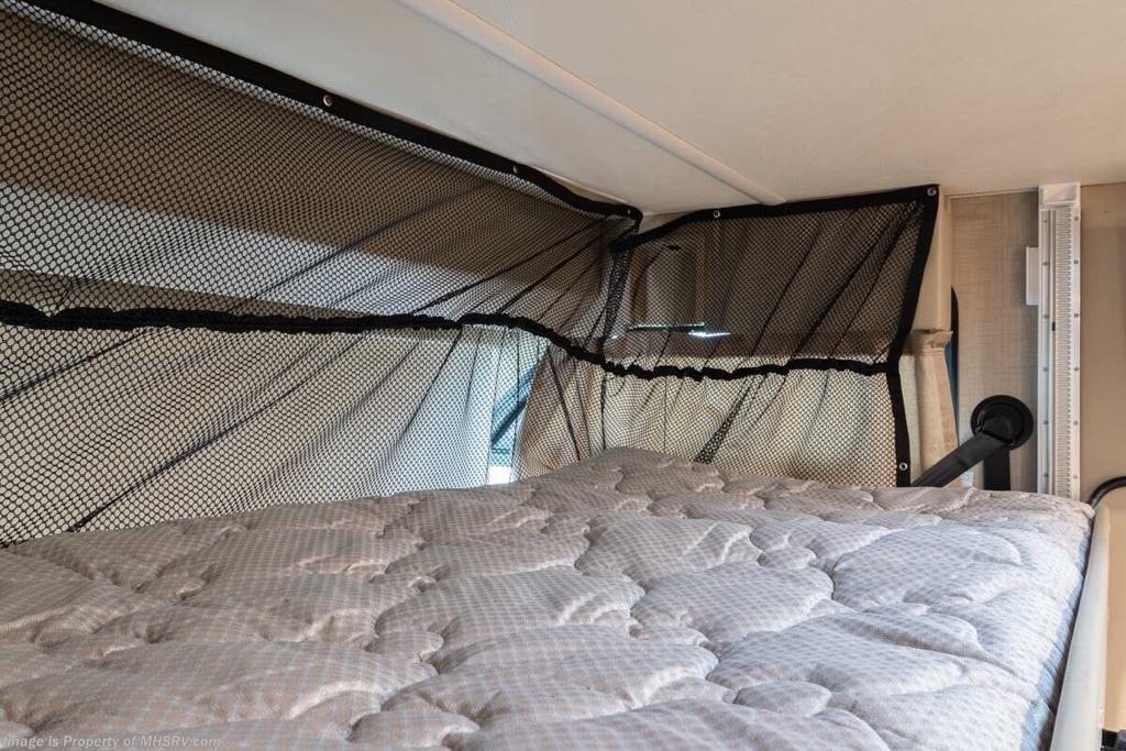 View of an RV rental's overhead bunk bed, featuring a mattress and crucial safety netting.. Thor Motor Coach Vegas 24.1 2020